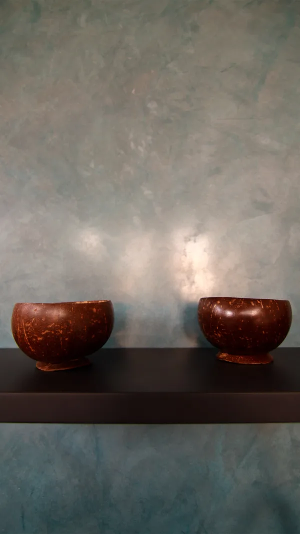 A closer look at the custom blue Artisan Stucco waterproof plaster reveals the subtle depth and movement created by natural lime and marble sands. The silky, smooth surface catches the light beautifully, giving the wall a lively, almost shimmering texture without losing its modern refinement.